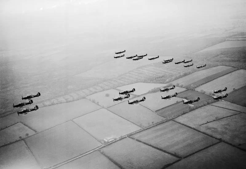 A line of Hurricanes followed by a line of Spitfires flying in formation